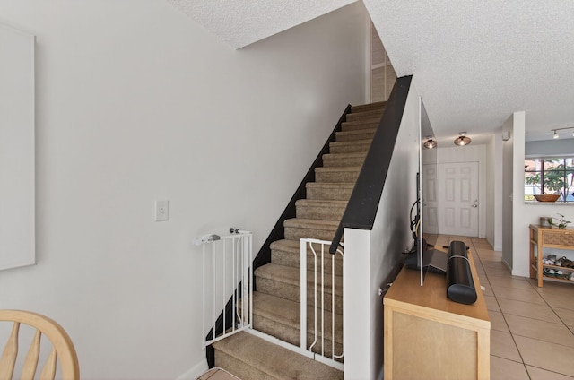 9931 Kamena Cir, Boynton Beach, FL 33436 - staircase with a textured ceiling and tile patterned flooring