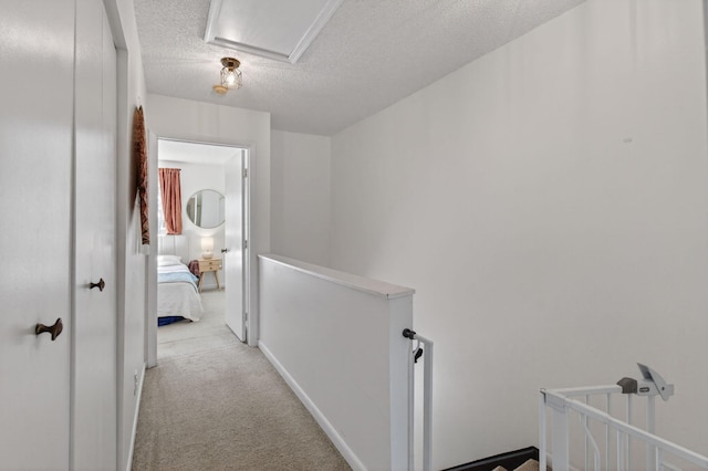 9931 Kamena Cir, Boynton Beach, FL 33436 - corridor featuring an upstairs landing, a textured ceiling, and carpet floors