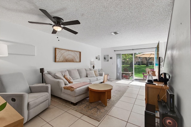 9931 Kamena Cir, Boynton Beach, FL 33436 - living area with light tile patterned floors, ceiling fan, and a textured ceiling