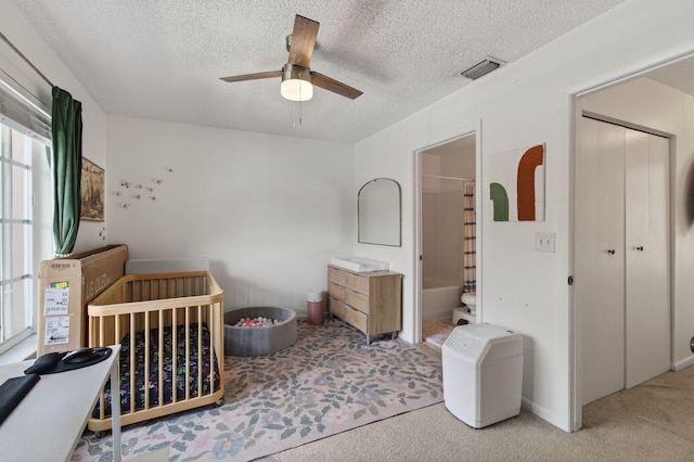 9931 Kamena Cir, Boynton Beach, FL 33436 - bedroom with carpet floors, a textured ceiling, a ceiling fan, and a crib