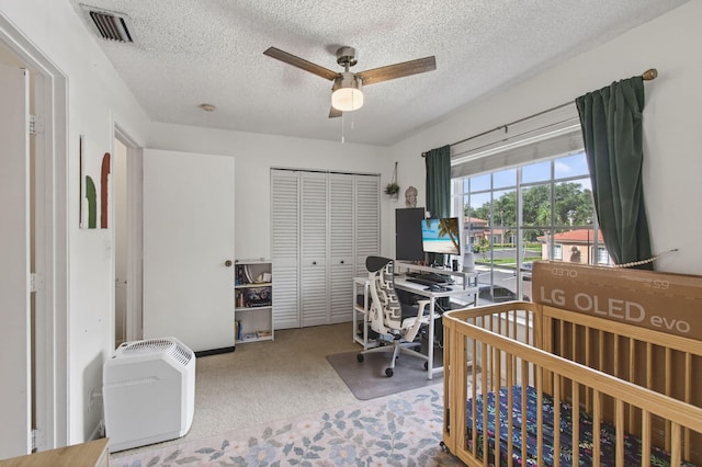 9931 Kamena Cir, Boynton Beach, FL 33436 - bedroom with an office area, a textured ceiling, a closet, carpet floors, and a ceiling fan
