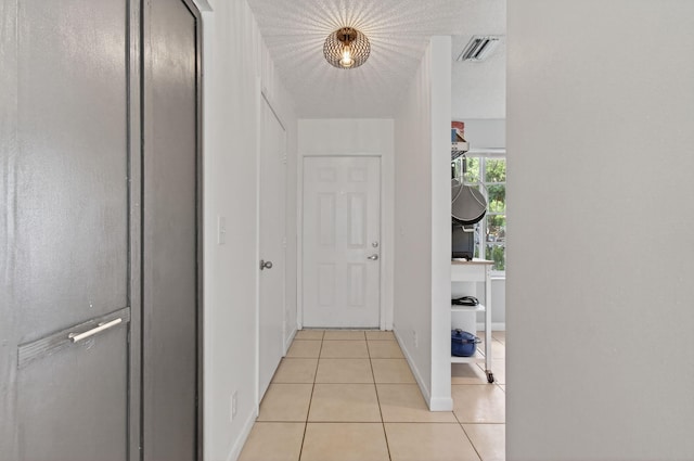 9931 Kamena Cir, Boynton Beach, FL 33436 - hallway with light tile patterned floors and baseboards