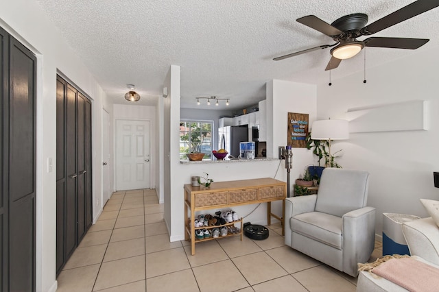 9931 Kamena Cir, Boynton Beach, FL 33436 - living room featuring a textured ceiling, light tile patterned floors, ceiling fan, and track lighting