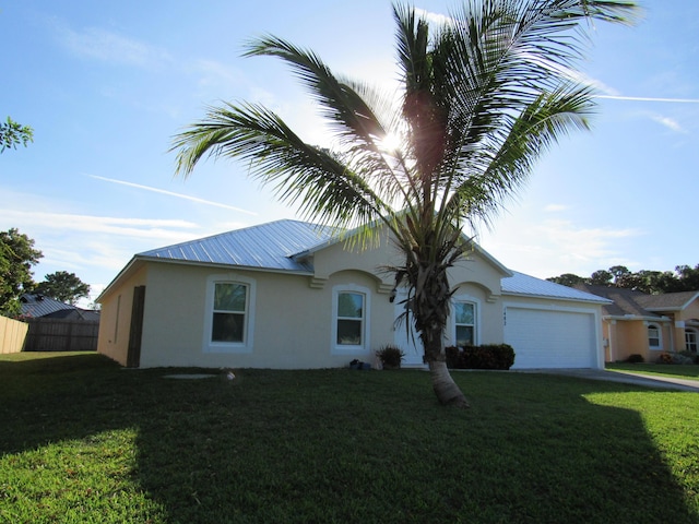 1482 SE Kirke Ln, Port Saint Lucie, FL 34983 - view of front of house featuring stucco siding, a garage, a metal roof, and driveway