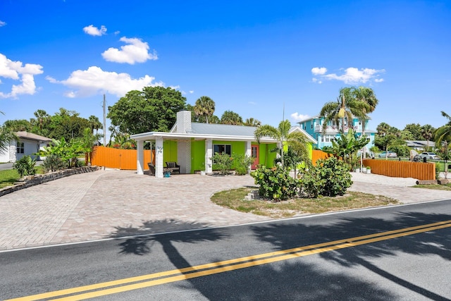 5203 S Indian River Dr, Fort Pierce, FL 34982 - view of front facade featuring decorative driveway and a chimney