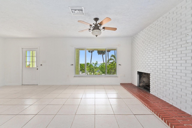 5203 S Indian River Dr, Fort Pierce, FL 34982 - unfurnished living room featuring a fireplace, a ceiling fan, light tile patterned floors, a textured ceiling, and brick wall