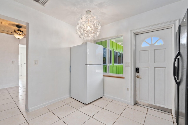 5203 S Indian River Dr, Fort Pierce, FL 34982 - foyer entrance featuring light tile patterned floors, a chandelier, and a ceiling fan
