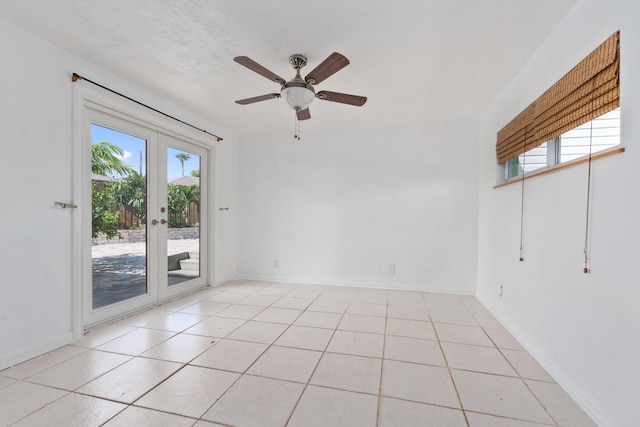 5203 S Indian River Dr, Fort Pierce, FL 34982 - spare room featuring healthy amount of natural light, french doors, ceiling fan, and light tile patterned flooring