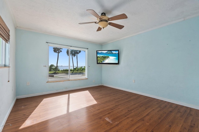 5203 S Indian River Dr, Fort Pierce, FL 34982 - unfurnished room featuring healthy amount of natural light, a ceiling fan, a textured ceiling, ornamental molding, and wood finished floors