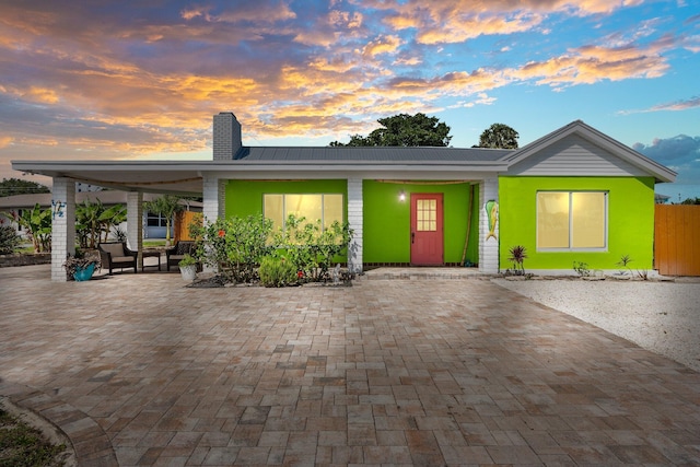 5203 S Indian River Dr, Fort Pierce, FL 34982 - view of front of home featuring a chimney and a metal roof