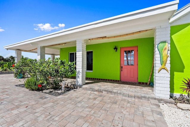 5203 S Indian River Dr, Fort Pierce, FL 34982 - view of exterior entry featuring a patio area