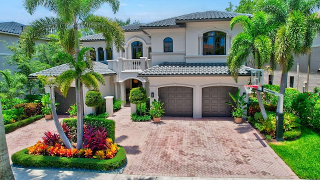 17865 Monte Vista Dr, Boca Raton, FL 33496 - mediterranean / spanish home featuring a tile roof, a balcony, an attached garage, and decorative driveway