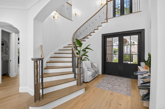 17865 Monte Vista Dr, Boca Raton, FL 33496 - foyer entrance with arched walkways, wood finished floors, plenty of natural light, stairs, and a high ceiling