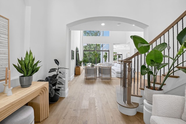 17865 Monte Vista Dr, Boca Raton, FL 33496 - entrance foyer featuring arched walkways, stairs, light wood-type flooring, and a high ceiling