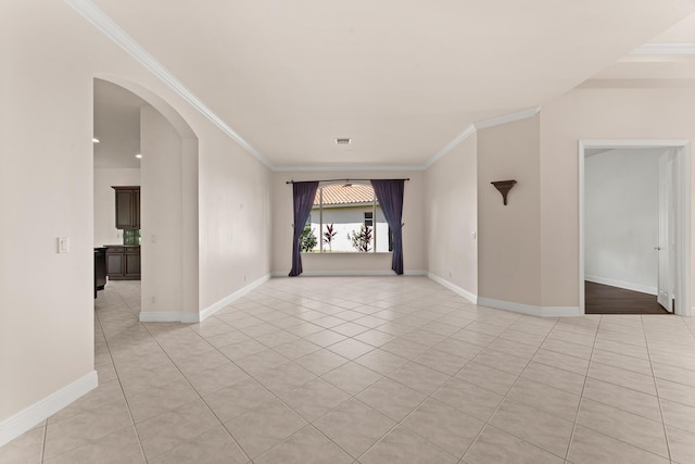 879 SW Pebble Ln, Palm City, FL 34990 - empty room with arched walkways, light tile patterned flooring, and crown molding