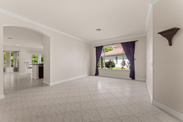 879 SW Pebble Ln, Palm City, FL 34990 - unfurnished room featuring crown molding, light tile patterned floors, and arched walkways