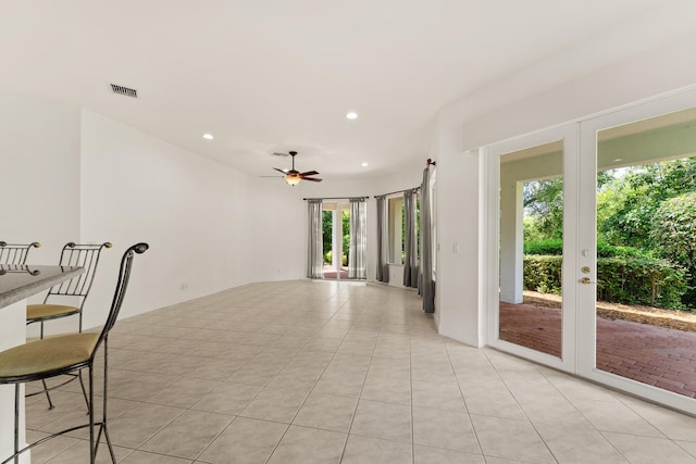 879 SW Pebble Ln, Palm City, FL 34990 - empty room with a ceiling fan, recessed lighting, light tile patterned floors, and french doors