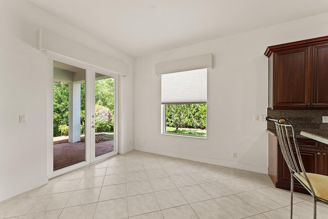 879 SW Pebble Ln, Palm City, FL 34990 - unfurnished dining area featuring baseboards and light tile patterned floors