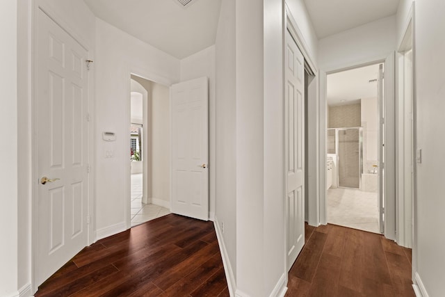 879 SW Pebble Ln, Palm City, FL 34990 - corridor with dark wood finished floors and arched walkways