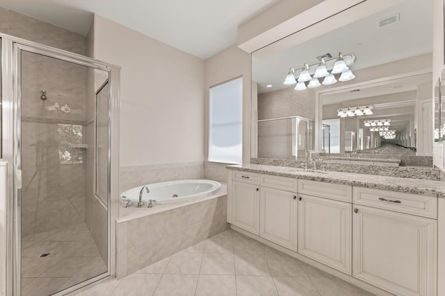879 SW Pebble Ln, Palm City, FL 34990 - full bath with a garden tub, a shower stall, vanity, tile patterned floors, and a chandelier