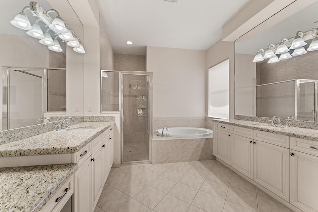 879 SW Pebble Ln, Palm City, FL 34990 - bathroom with two vanities, tile patterned flooring, a shower stall, and a garden tub