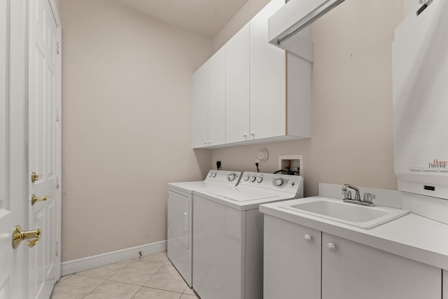 879 SW Pebble Ln, Palm City, FL 34990 - laundry room featuring cabinet space, washer and dryer, and light tile patterned floors