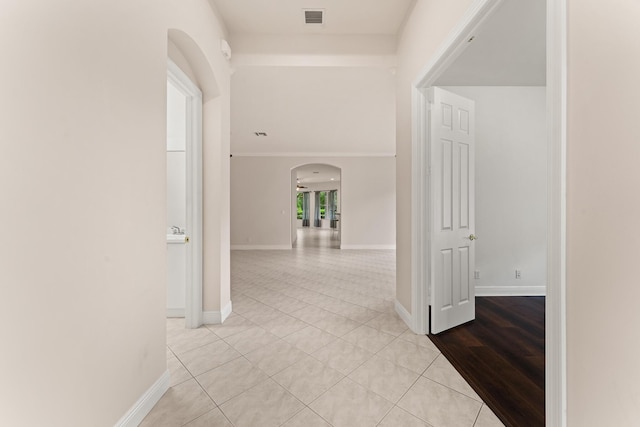 879 SW Pebble Ln, Palm City, FL 34990 - hallway featuring arched walkways and light tile patterned floors