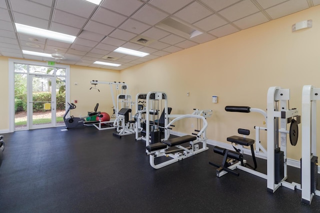 879 SW Pebble Ln, Palm City, FL 34990 - exercise room featuring a drop ceiling and baseboards