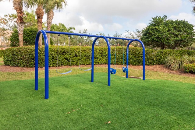 879 SW Pebble Ln, Palm City, FL 34990 - community playground featuring a lawn