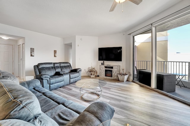 804 E Windward Way Unit 606, Lantana, FL 33462 - living area featuring light wood-type flooring, a ceiling fan, and a glass covered fireplace