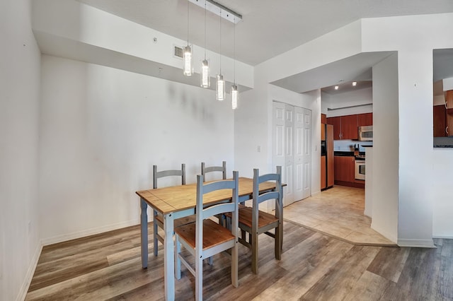 804 E Windward Way Unit 606, Lantana, FL 33462 - dining room featuring light wood-style floors and baseboards