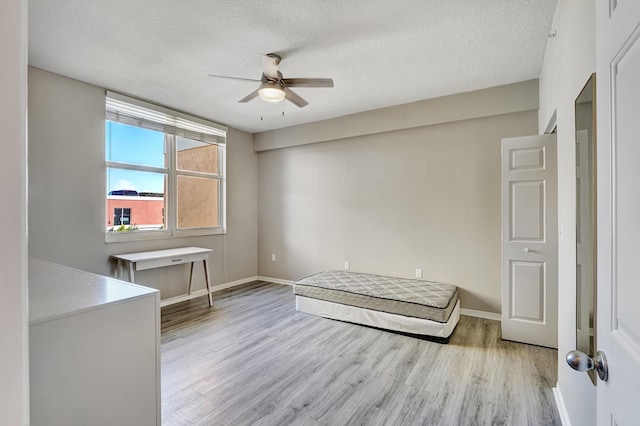 804 E Windward Way Unit 606, Lantana, FL 33462 - unfurnished bedroom featuring wood finished floors, a textured ceiling, and ceiling fan