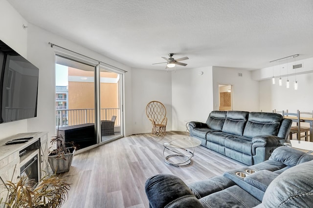 804 E Windward Way Unit 606, Lantana, FL 33462 - living area featuring light wood-type flooring, ceiling fan, and a textured ceiling