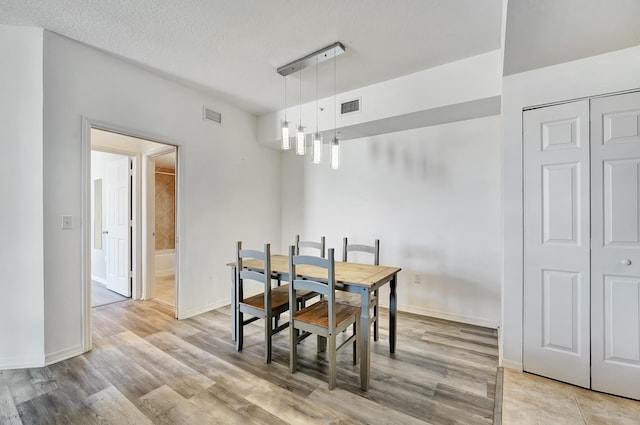 804 E Windward Way Unit 606, Lantana, FL 33462 - dining area featuring wood finished floors and a textured ceiling