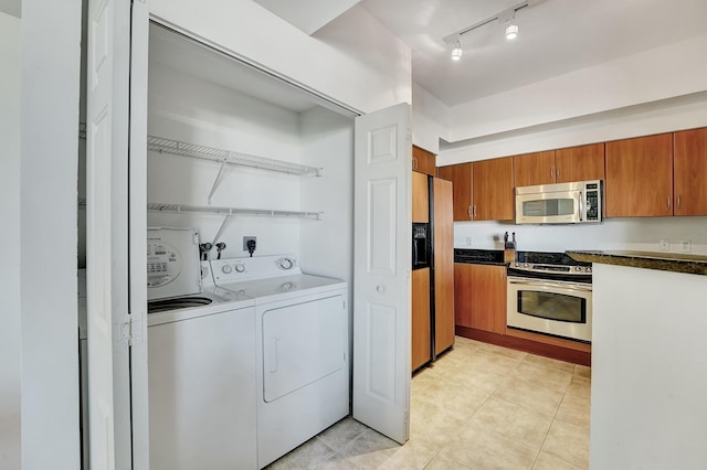 804 E Windward Way Unit 606, Lantana, FL 33462 - washroom with rail lighting, washer and clothes dryer, and light tile patterned floors