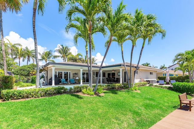 4220 NE 24th Ave, Lighthouse Point, FL 33064 - back of property with a ceiling fan, stucco siding, and a patio