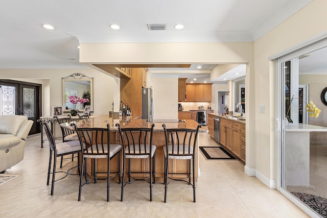 4220 NE 24th Ave, Lighthouse Point, FL 33064 - kitchen with beverage cooler, appliances with stainless steel finishes, a peninsula, a kitchen breakfast bar, and crown molding
