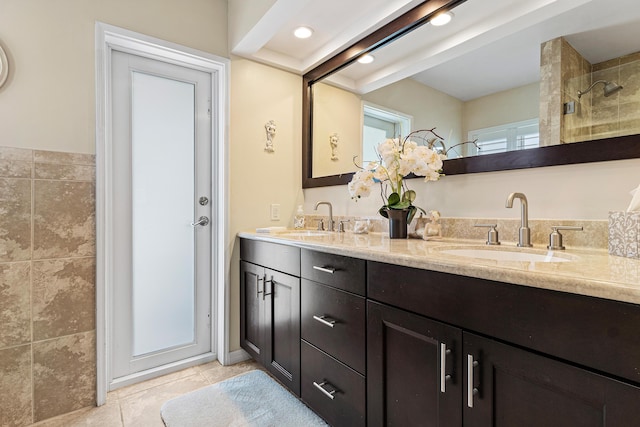 4220 NE 24th Ave, Lighthouse Point, FL 33064 - bathroom featuring double vanity, tile patterned flooring, and tiled shower