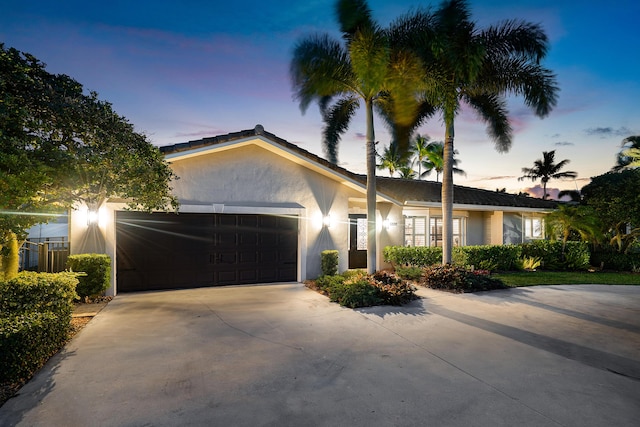 4220 NE 24th Ave, Lighthouse Point, FL 33064 - single story home featuring an attached garage, stucco siding, and driveway