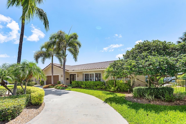 4220 NE 24th Ave, Lighthouse Point, FL 33064 - single story home with stucco siding, an attached garage, a tiled roof, and concrete driveway