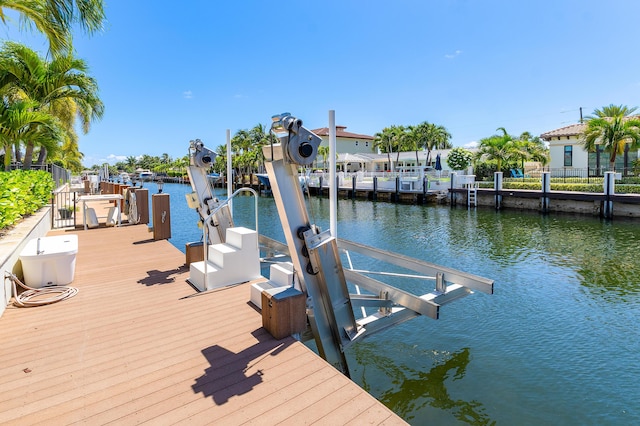 4220 NE 24th Ave, Lighthouse Point, FL 33064 - dock area with boat lift and a water view