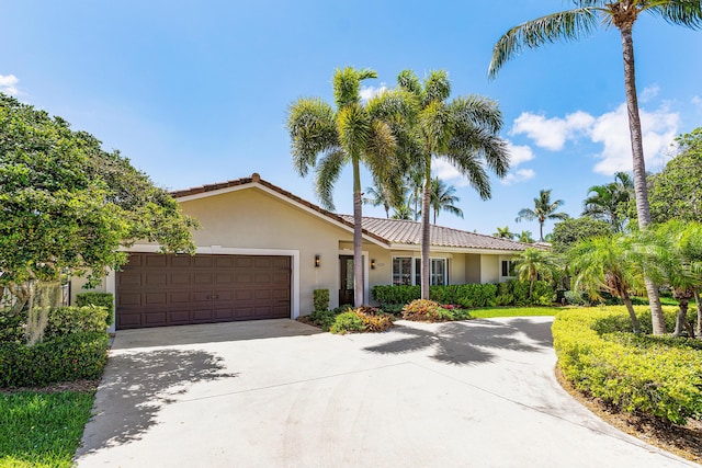 4220 NE 24th Ave, Lighthouse Point, FL 33064 - ranch-style home with stucco siding, an attached garage, concrete driveway, and a tile roof