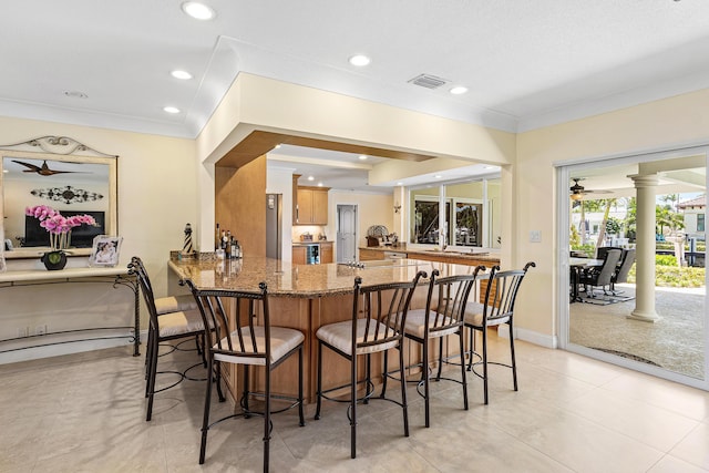 4220 NE 24th Ave, Lighthouse Point, FL 33064 - bar area with ornate columns, crown molding, recessed lighting, and light tile patterned floors