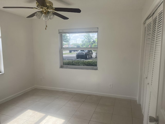 2548 Ida Way Unit 3A, West Palm Beach, FL 33415 - unfurnished bedroom featuring light tile patterned floors, a closet, and ceiling fan