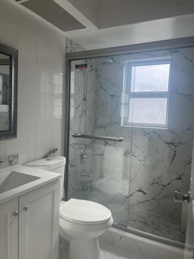 2548 Ida Way Unit 3A, West Palm Beach, FL 33415 - bathroom with vanity, a marble finish shower, tile walls, and marble finish floors