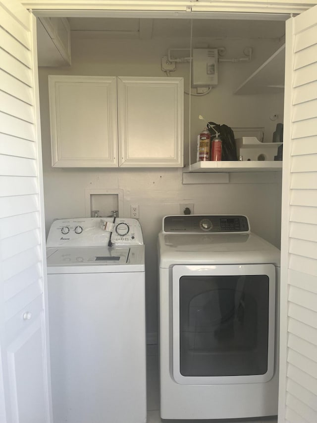 2548 Ida Way Unit 3A, West Palm Beach, FL 33415 - laundry room featuring washer and dryer and cabinet space