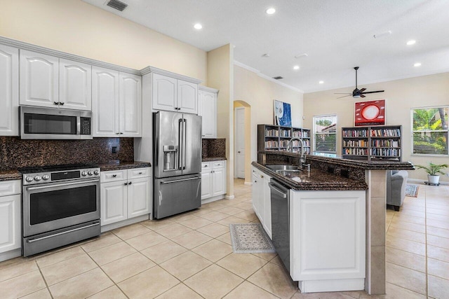 5422 Landon Cir, Boynton Beach, FL 33437 - kitchen featuring appliances with stainless steel finishes, ceiling fan, light tile patterned flooring, crown molding, and tasteful backsplash