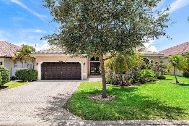 5336 NW 57th Way, Coral Springs, FL 33067 - mediterranean / spanish house with an attached garage, decorative driveway, stucco siding, and a tiled roof