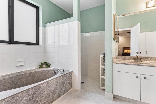 5336 NW 57th Way, Coral Springs, FL 33067 - bathroom featuring a bath, vanity, marble finish floors, walk in shower, and tile walls