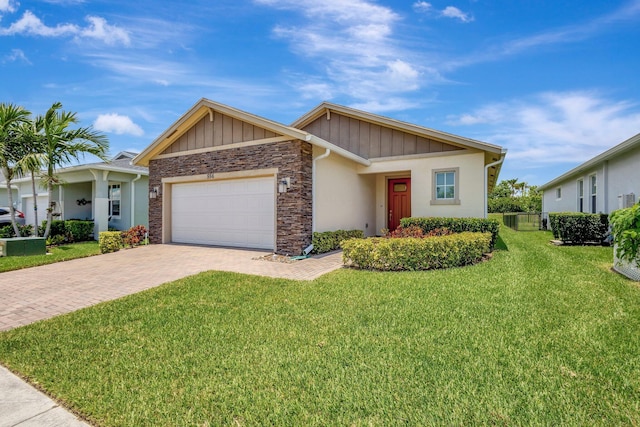 556 SE Mulberry Way, Port Saint Lucie, FL 34984 - view of front facade with decorative driveway, a garage, stone siding, and board and batten siding